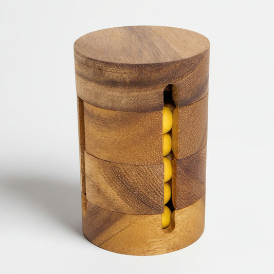 Wooden cylindrical container with yellow beads on a white background