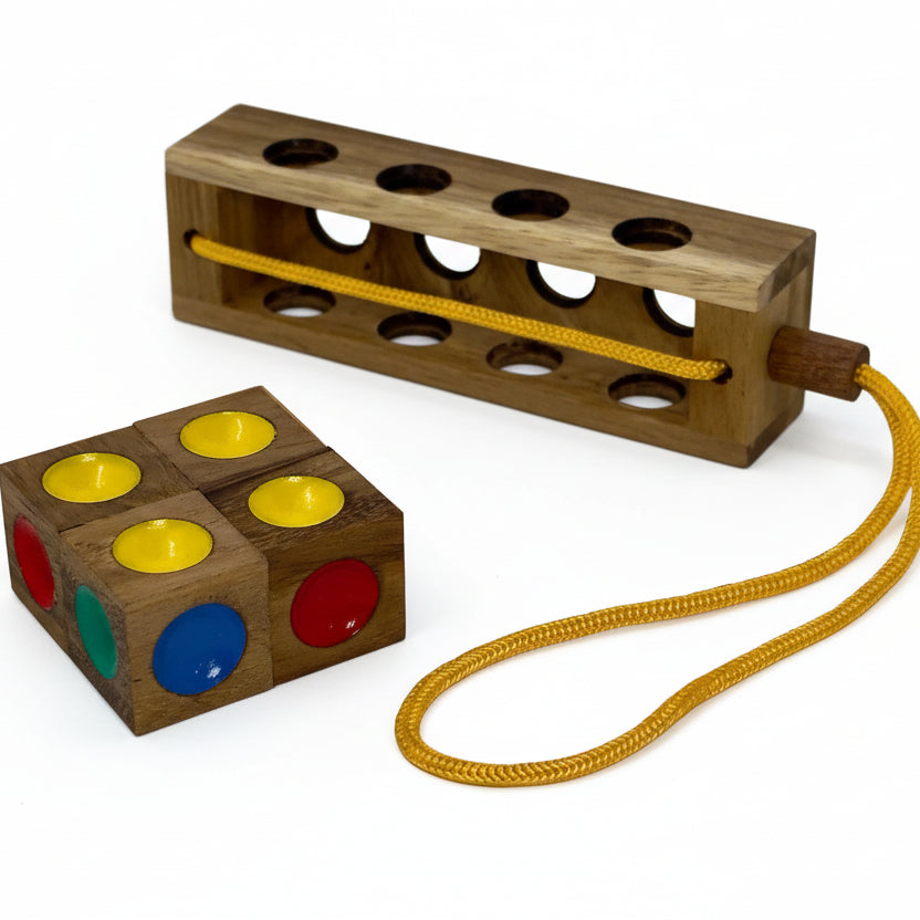 Wooden toy with colorful dots and a yellow string on a light gray background