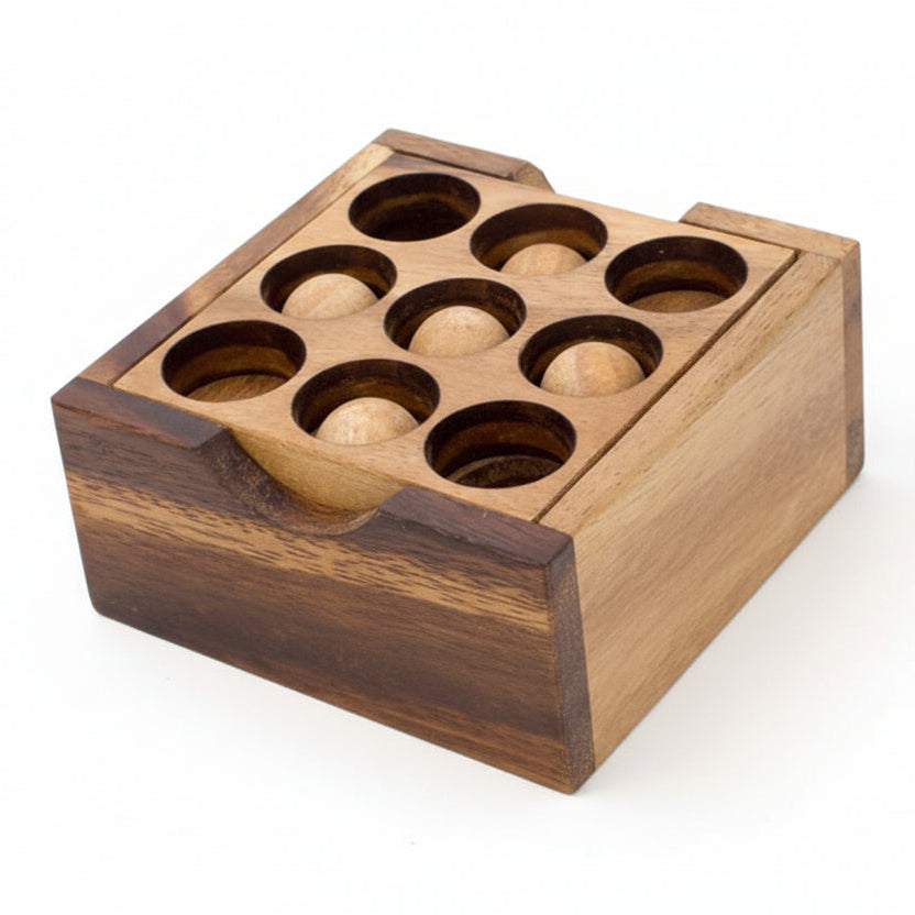 Wooden puzzle box with a 9-hole grid and spherical components on a white background