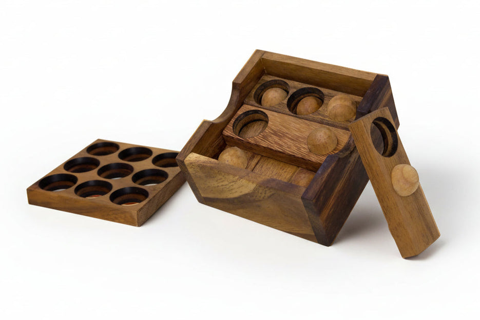 Wooden puzzle box with some pieces laying next to the box